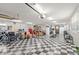 The spacious garage is painted white with a black and white checkerboard floor at 793 Timothy St, Ormond Beach, FL 32174