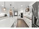 Open kitchen boasts a large island, stainless steel appliances, and custom cabinetry at 793 Timothy St, Ormond Beach, FL 32174