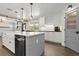 Bright and airy kitchen featuring an island with sink, stainless steel appliances, and wood flooring at 793 Timothy St, Ormond Beach, FL 32174