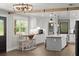 Bright kitchen features an island, farmhouse sink, stainless appliances, and a breakfast nook with a wooden table at 793 Timothy St, Ormond Beach, FL 32174