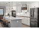 Gourmet kitchen featuring an island, stainless steel appliances, and custom cabinets at 793 Timothy St, Ormond Beach, FL 32174
