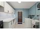 The laundry room features a white countertop and cabinets against blue painted brick walls at 793 Timothy St, Ormond Beach, FL 32174