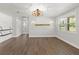 Open-concept living room with recessed lights, wood-look flooring, and a decorative wood beam accent wall at 793 Timothy St, Ormond Beach, FL 32174