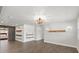Spacious living room with a decorative accent wall and wood shelving, offering a blend of style and functionality at 793 Timothy St, Ormond Beach, FL 32174