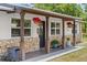 Covered porch with stone columns and hanging flower baskets at 793 Timothy St, Ormond Beach, FL 32174