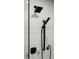 A detail shot of a walk-in shower features black fixtures against white subway tile at 793 Timothy St, Ormond Beach, FL 32174