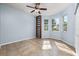 Bright bedroom with tile floors, built-in shelving, and two windows at 8231 Sw 79Th Ct, Ocala, FL 34476