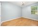 Spacious bedroom with hardwood floors, a chandelier, and one window at 8231 Sw 79Th Ct, Ocala, FL 34476