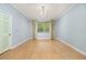 Bright bedroom with wood floors, large window with backyard view, and fresh paint at 8231 Sw 79Th Ct, Ocala, FL 34476