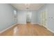Spacious bedroom with wood flooring, fresh paint, large window, and ensuite bathroom at 8231 Sw 79Th Ct, Ocala, FL 34476