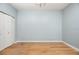 Empty bedroom features hardwood floors, overhead lighting, and a double door closet at 8231 Sw 79Th Ct, Ocala, FL 34476