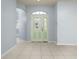Bright foyer with tile flooring, showcasing an arched doorway and a decorative glass front door at 8231 Sw 79Th Ct, Ocala, FL 34476