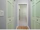 Hallway view into a bathroom, featuring mint green doors and a striped accent wall at 8231 Sw 79Th Ct, Ocala, FL 34476