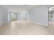 Spacious living room with tile flooring, light blue walls, and plenty of natural light at 8231 Sw 79Th Ct, Ocala, FL 34476