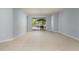Open-concept living area with tile floors, leading to an outdoor patio with screened enclosure at 8231 Sw 79Th Ct, Ocala, FL 34476