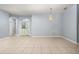 Spacious living room with tile floors and light blue walls, featuring a decorative chandelier at 8231 Sw 79Th Ct, Ocala, FL 34476