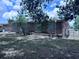 View of brick house backyard featuring brick detail and a well-manicured lawn at 891 S Atmore Cir, Deltona, FL 32725