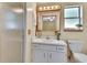 Clean bathroom featuring a glass shower, a toilet, and a vanity with ample lighting and decor at 941 Village Lake N Dr, Deland, FL 32724