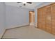 Carpeted bedroom featuring a closet and access to the hall at 941 Village Lake N Dr, Deland, FL 32724
