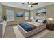 Inviting bedroom with neutral walls, plush carpeting, modern decor, and plenty of natural light at 941 Village Lake N Dr, Deland, FL 32724