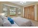Cozy bedroom with a large bed, natural light and a closet at 941 Village Lake N Dr, Deland, FL 32724