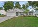 Charming single-story home featuring a well-maintained lawn and attached garage at 941 Village Lake N Dr, Deland, FL 32724