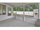 Screened patio leading to backyard, with a view of storage shed and vinyl fencing at 941 Village Lake N Dr, Deland, FL 32724