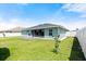 Green grass, screen porch, and a view of the backyard of the house in a fully fenced yard at 979 Leyburn Dr, Deltona, FL 32725