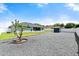 Wide backyard with gravel area, storage shed, and green grass, featuring a screen porch on the home at 979 Leyburn Dr, Deltona, FL 32725