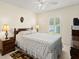 Cozy bedroom featuring a queen-sized bed, ceiling fan, and a window with shutters at 979 Leyburn Dr, Deltona, FL 32725