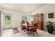 Traditional dining room with a hutch, chandelier, and natural light from the window at 979 Leyburn Dr, Deltona, FL 32725