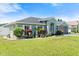 Well-manicured lawn and diverse landscaping complement this attractive single-story home at 979 Leyburn Dr, Deltona, FL 32725
