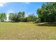 A view of a large lot with chainlink fence, perfect for development at 979 Leyburn Dr, Deltona, FL 32725