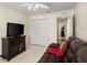 Comfortable living room with a leather couch, TV, closet, and tile flooring at 979 Leyburn Dr, Deltona, FL 32725