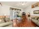Inviting living room with hardwood floors, a vaulted ceiling, and access to a screened lanai at 979 Leyburn Dr, Deltona, FL 32725