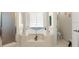 Luxurious main bathroom featuring a soaking tub, columns, neutral tile, and separate shower at 979 Leyburn Dr, Deltona, FL 32725