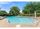 Community pool with lounge chairs and mature landscaping in a securely fenced area at 979 Leyburn Dr, Deltona, FL 32725
