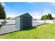 Backyard storage shed on a gravel pad with a brick border in a fully fenced yard with green grass at 979 Leyburn Dr, Deltona, FL 32725