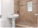 Cozy bathroom featuring tiled shower, pedestal sink, and a compact design for essential comfort and functionality at 706 W Franklin Ave, Deland, FL 32720