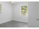 Bright bedroom with neutral walls, filled with natural light and practical design, offering a serene and simple retreat at 706 W Franklin Ave, Deland, FL 32720