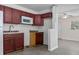 Functional kitchen featuring neutral walls, upper cabinets, and easy access to other living areas, blending style and practicality at 706 W Franklin Ave, Deland, FL 32720