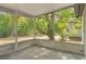 Screened in porch with concrete flooring and view of yard with mature trees at 706 W Franklin Ave, Deland, FL 32720