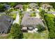 Aerial view of house with a backyard patio, fire pit, and lush landscaping at 10 Foxhunter Flt, Ormond Beach, FL 32174