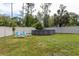 Backyard featuring a large above-ground pool, surrounded by lush lawn, and a privacy fence at 10 Foxhunter Flt, Ormond Beach, FL 32174