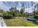 Expansive backyard featuring a pool, lawn, and mature trees for privacy at 10 Foxhunter Flt, Ormond Beach, FL 32174