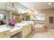 Bathroom featuring double vanity, jacuzzi tub, and bright lighting at 10 Foxhunter Flt, Ormond Beach, FL 32174