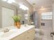 Bright bathroom features double vanity with decorative plants and separate shower and tub at 10 Foxhunter Flt, Ormond Beach, FL 32174