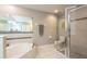 Bathroom featuring glass-enclosed shower, jacuzzi tub, and linen closet at 10 Foxhunter Flt, Ormond Beach, FL 32174
