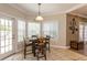 Bright breakfast nook with natural light, a table setting, and an exterior door that is great for indoor and outdoor dining at 10 Foxhunter Flt, Ormond Beach, FL 32174