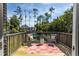 Outdoor deck with view of the yard, pool, and lush greenery, perfect for relaxation at 10 Foxhunter Flt, Ormond Beach, FL 32174